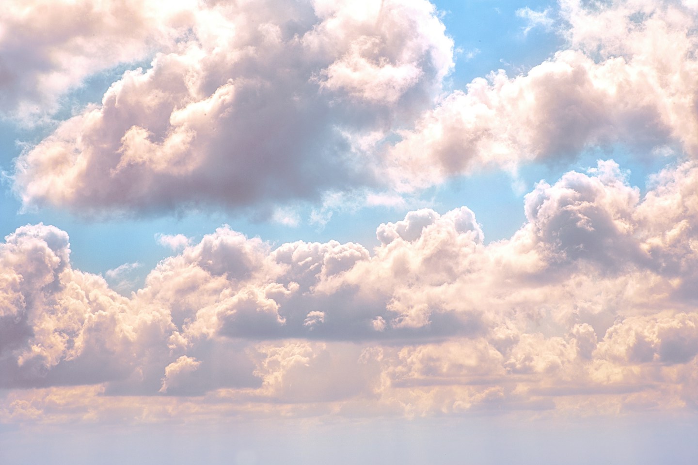 Soft white clouds against a bright blue sky, waiting for your imagination.